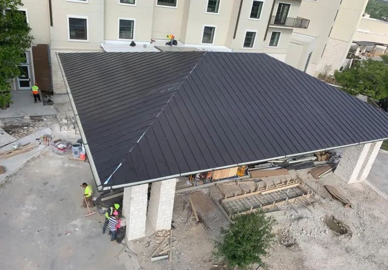 Metal roofing installation team working on a commercial building in Cresaptown